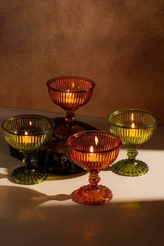 Genda Saaj candle holders showing vibrant amber orange and lime green glass craftsmanship