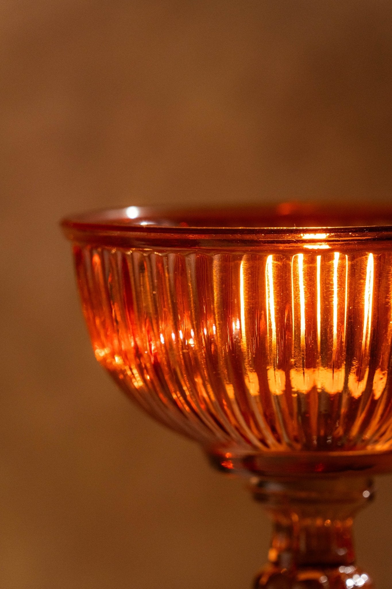 Side view of Genda Saaj candle holders displaying elegant glass construction and vibrant colors