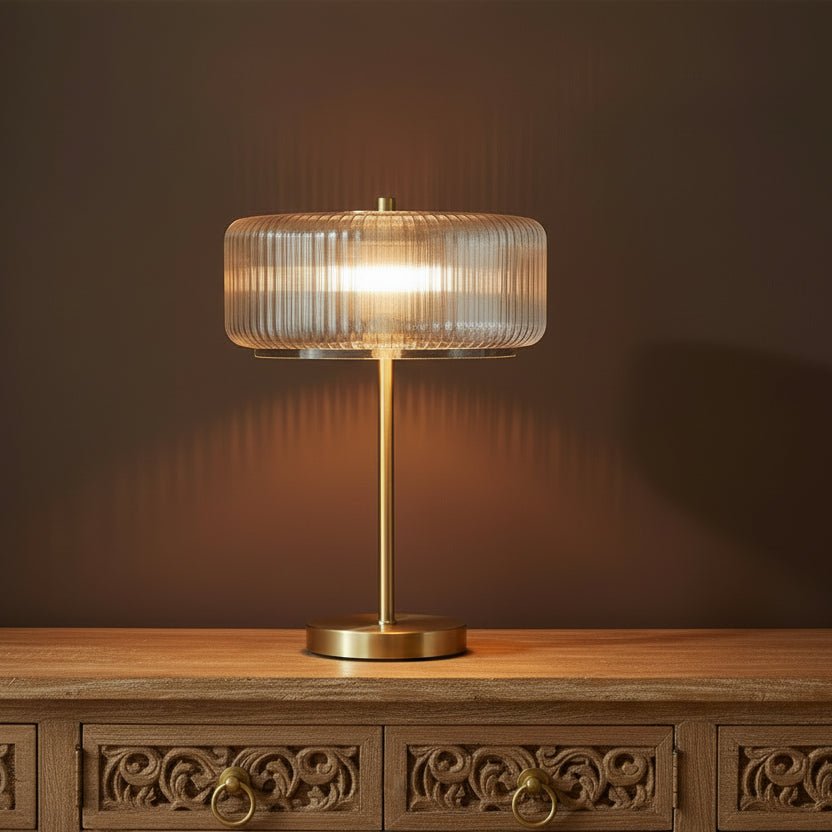 Modern side table with pink marble top and gold base in a living room setting.