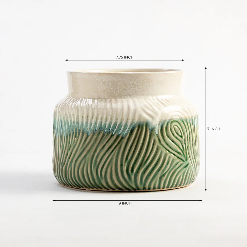 Ceramic planter with green and beige pattern and measurements on a white background