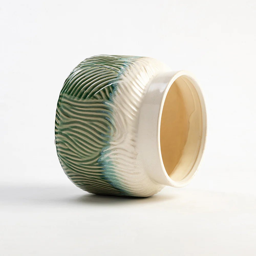 Ceramic ring with green and white pattern on a white background