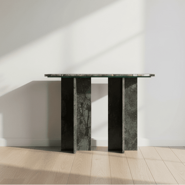 Console table with a glass top and dark marble base on a white background