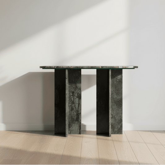 Console table with a glass top and dark marble base on a white background