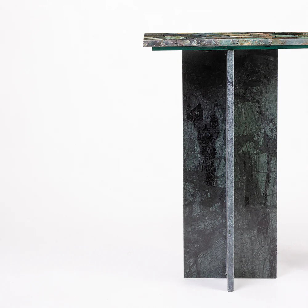 Marble console table with a green and black pattern on a white background