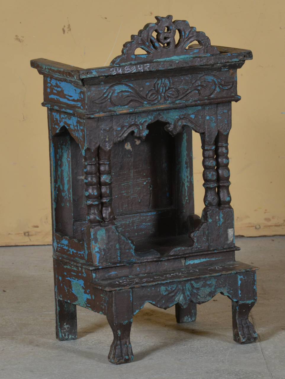 Decorative metal cabinet with intricate designs on a plain background