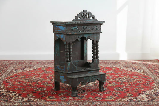 Vintage wooden cabinet with decorative carvings on a plain background
