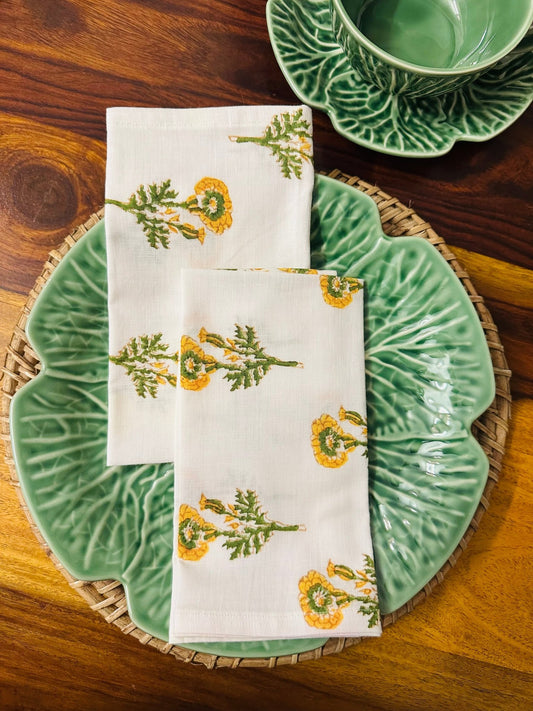 Napkin with floral pattern on a green plate on a wooden table