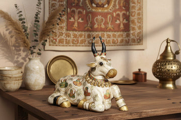 Decorative figurine of a bull with intricate designs on a white surface