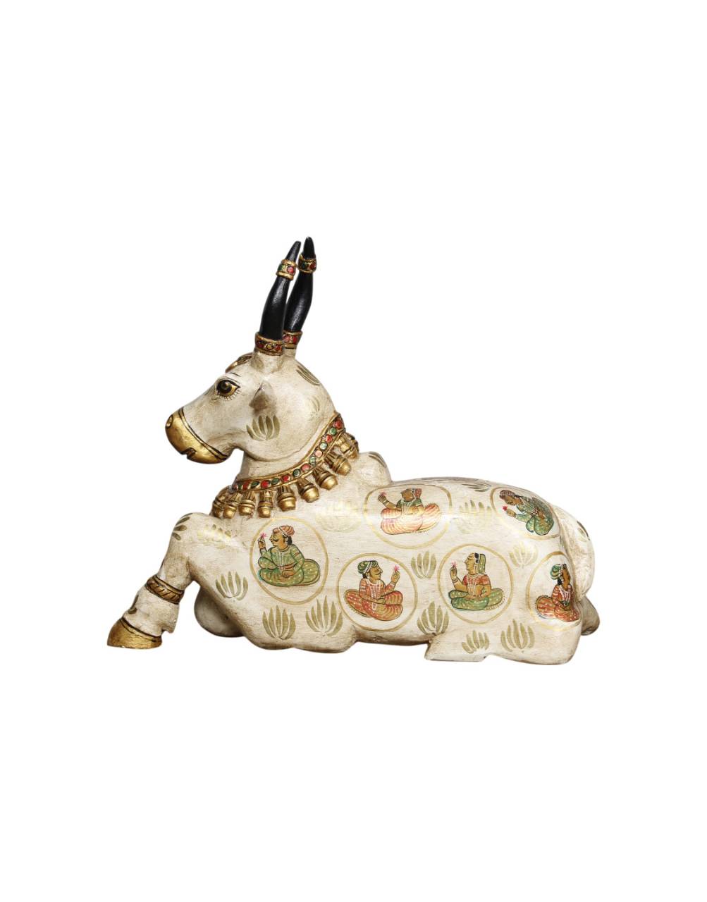 Decorative figurine of a cow with intricate designs on a white background
