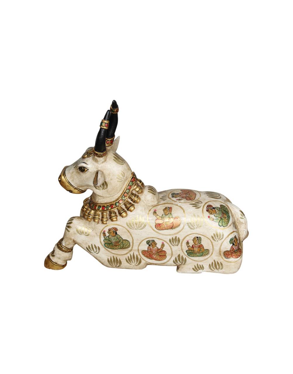 Decorative figurine of a cow with intricate designs on a white background