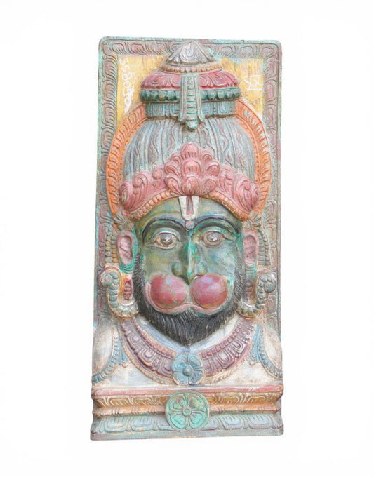 Decorative wall panel with a face design on a white background