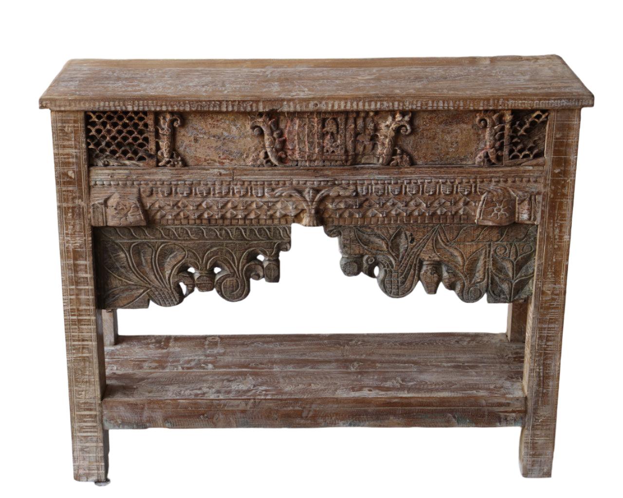 Carved wooden console table with intricate designs on a white background