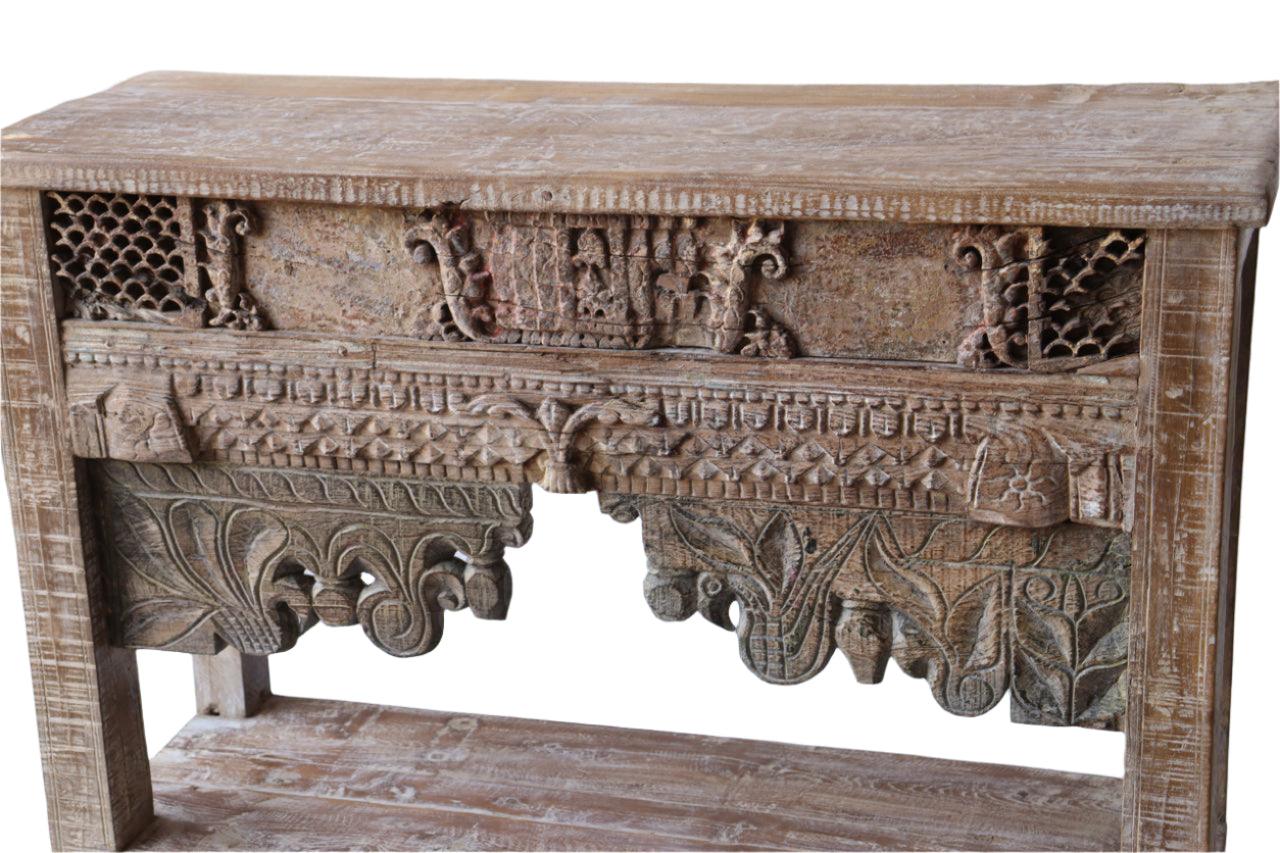 Wooden console table with intricate carvings on a white background