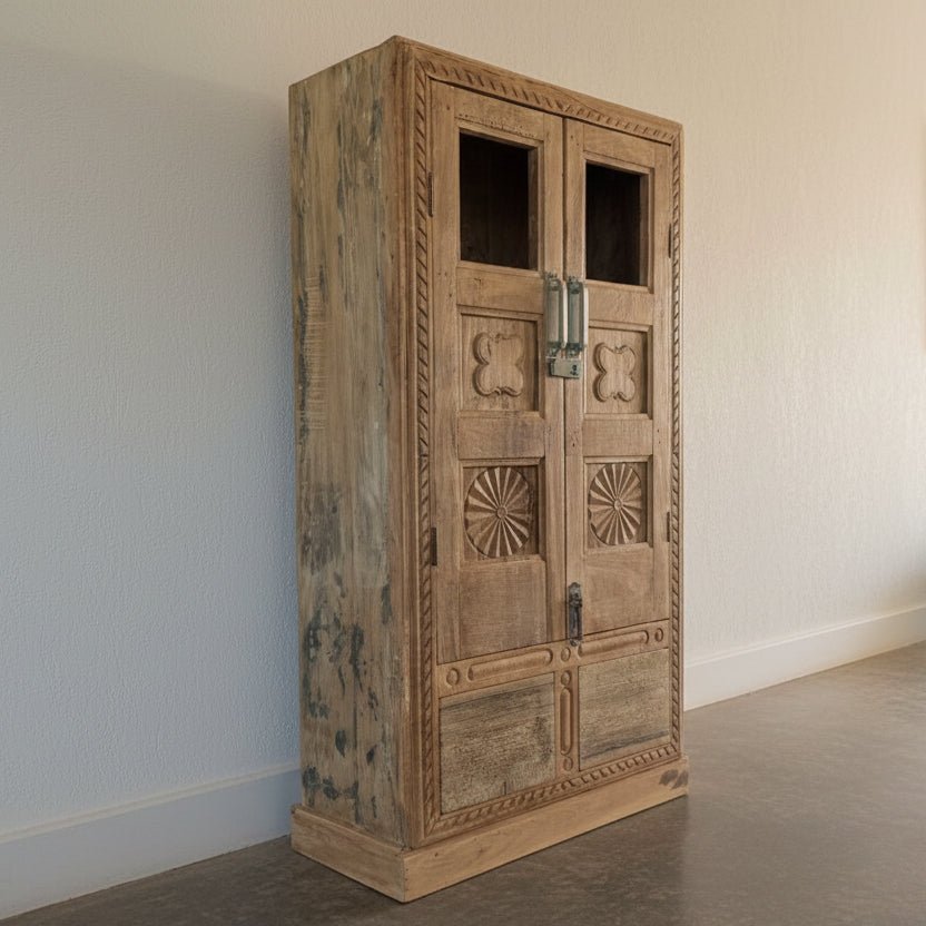 Wooden wardrobe with decorative carvings in a workshop setting