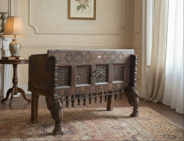 Vintage wooden chest with intricate carvings on a plain background