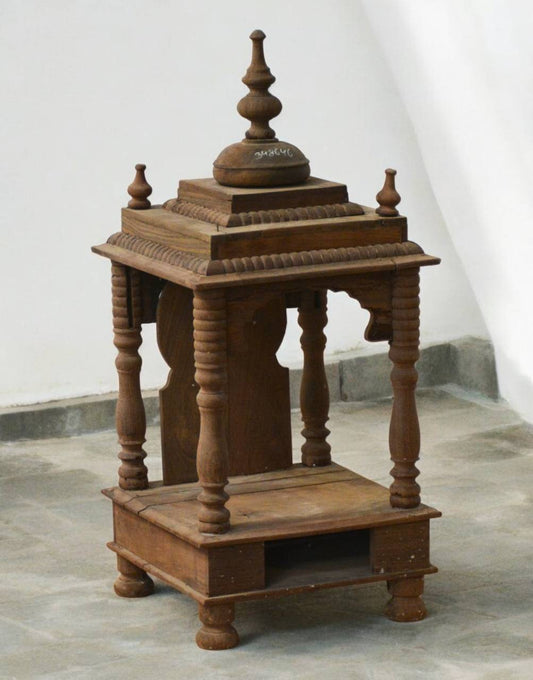 Wooden architectural model with intricate design on a plain background