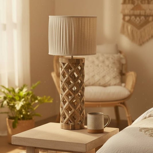 Wooden lamp with pleated shade on a table in a cozy living room.