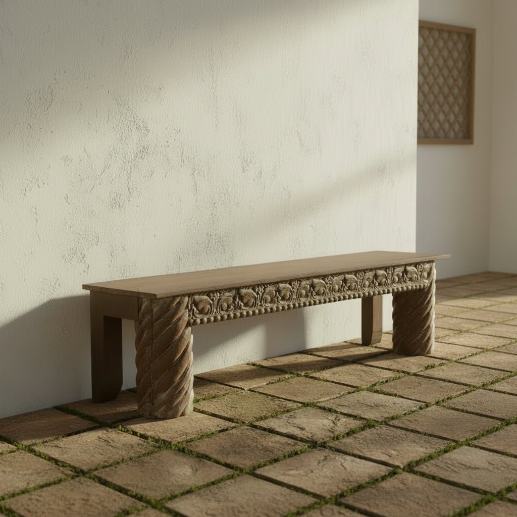 Wooden bench with intricate carvings on a plain background