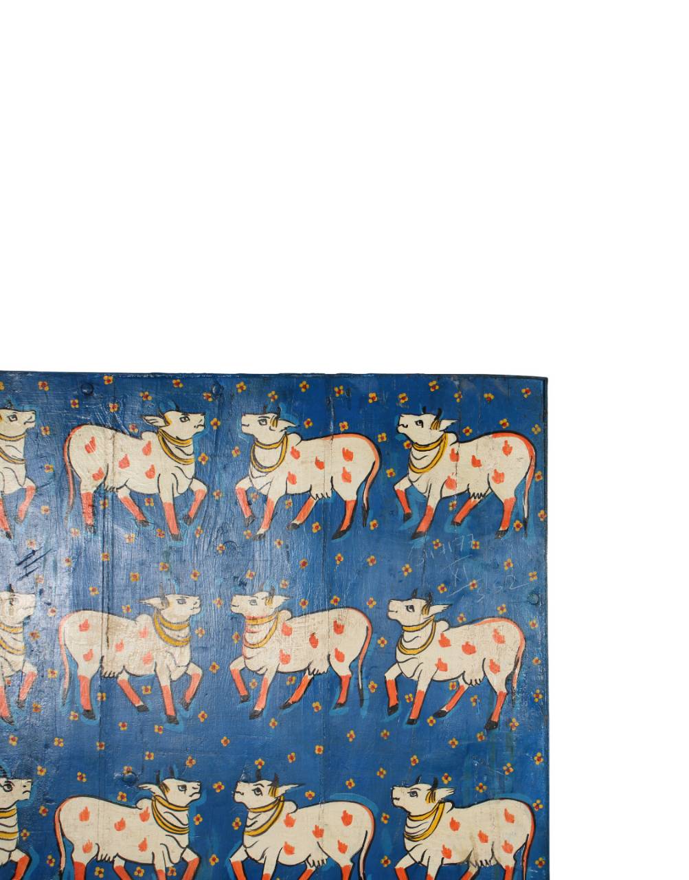 Patterned fabric with cows and orange dots on a blue background