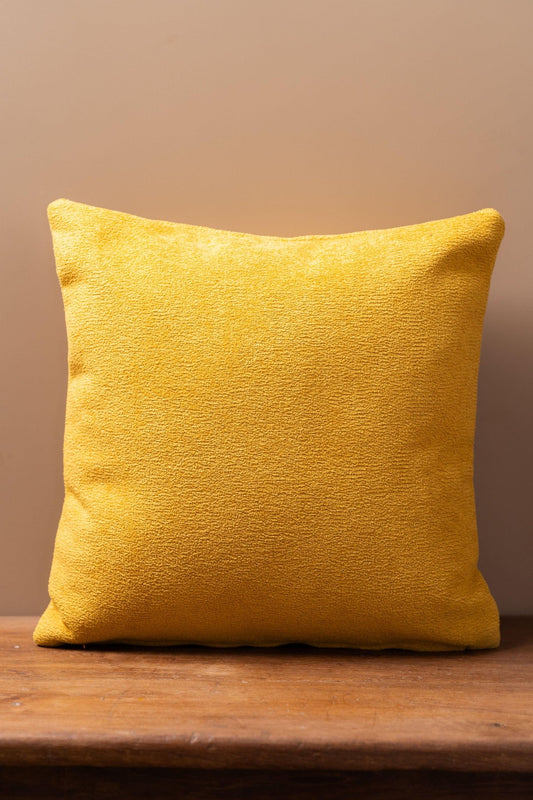 Close-up of boucle weave texture on bright yellow luxury cushion cover – Tesu Cushion Covers