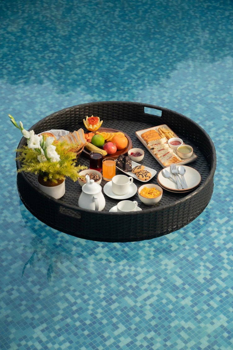 Luxury Round Floating Serving Tray with breakfast setup floating in pool - handwoven synthetic rattan waterproof.