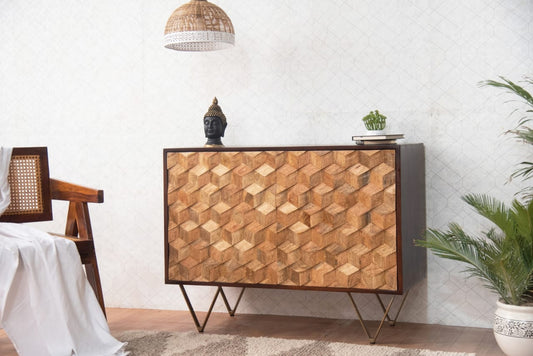 Wooden sideboard with geometric pattern in a room setting with a Buddha statue and plant.