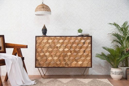 Wooden console table with geometric pattern in a room with plants and a chair.