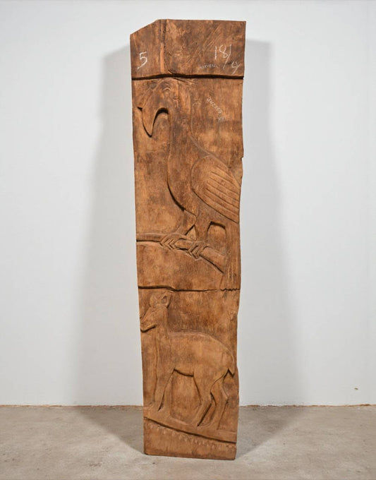 Wooden panel with carvings of a bird and deer on a plain background