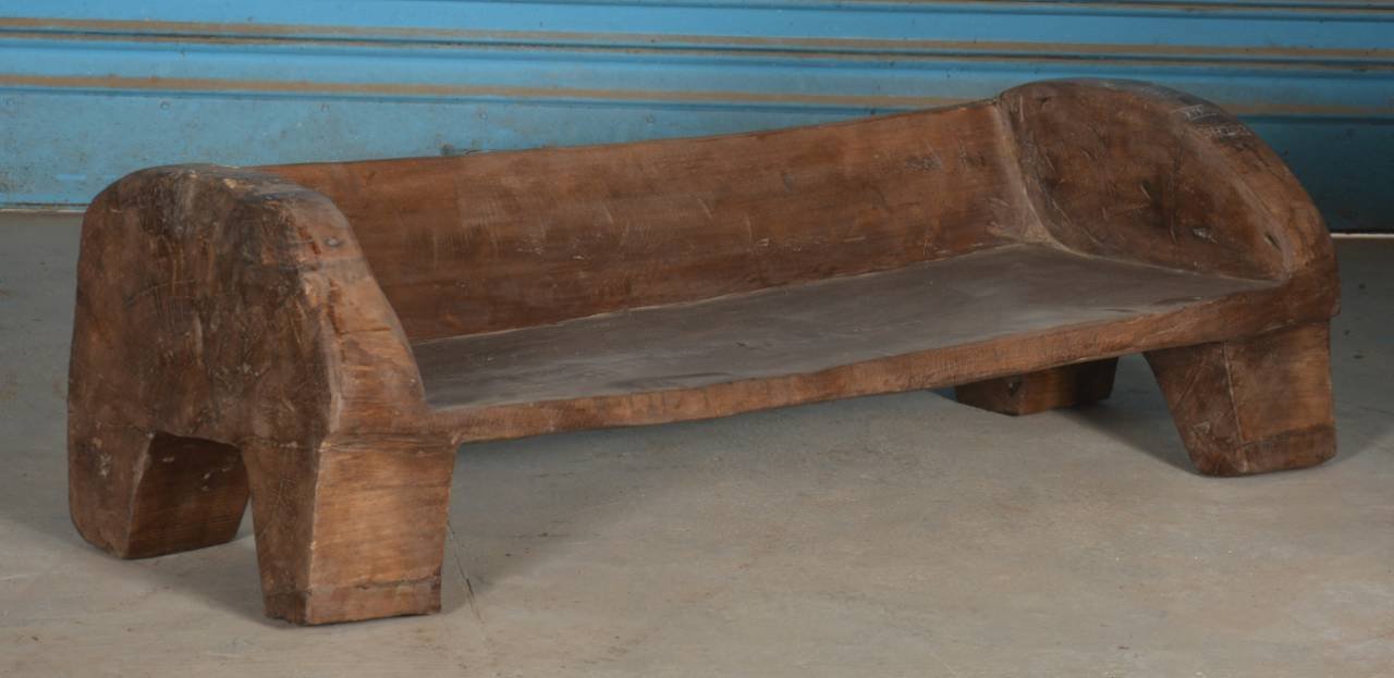 Wooden bench against a blue wall