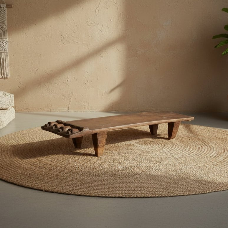 Wooden bench on a textured rug with a neutral wall background