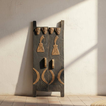 Decorative wooden panel with carvings against a light wall