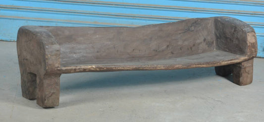 Wooden bench against a blue wall