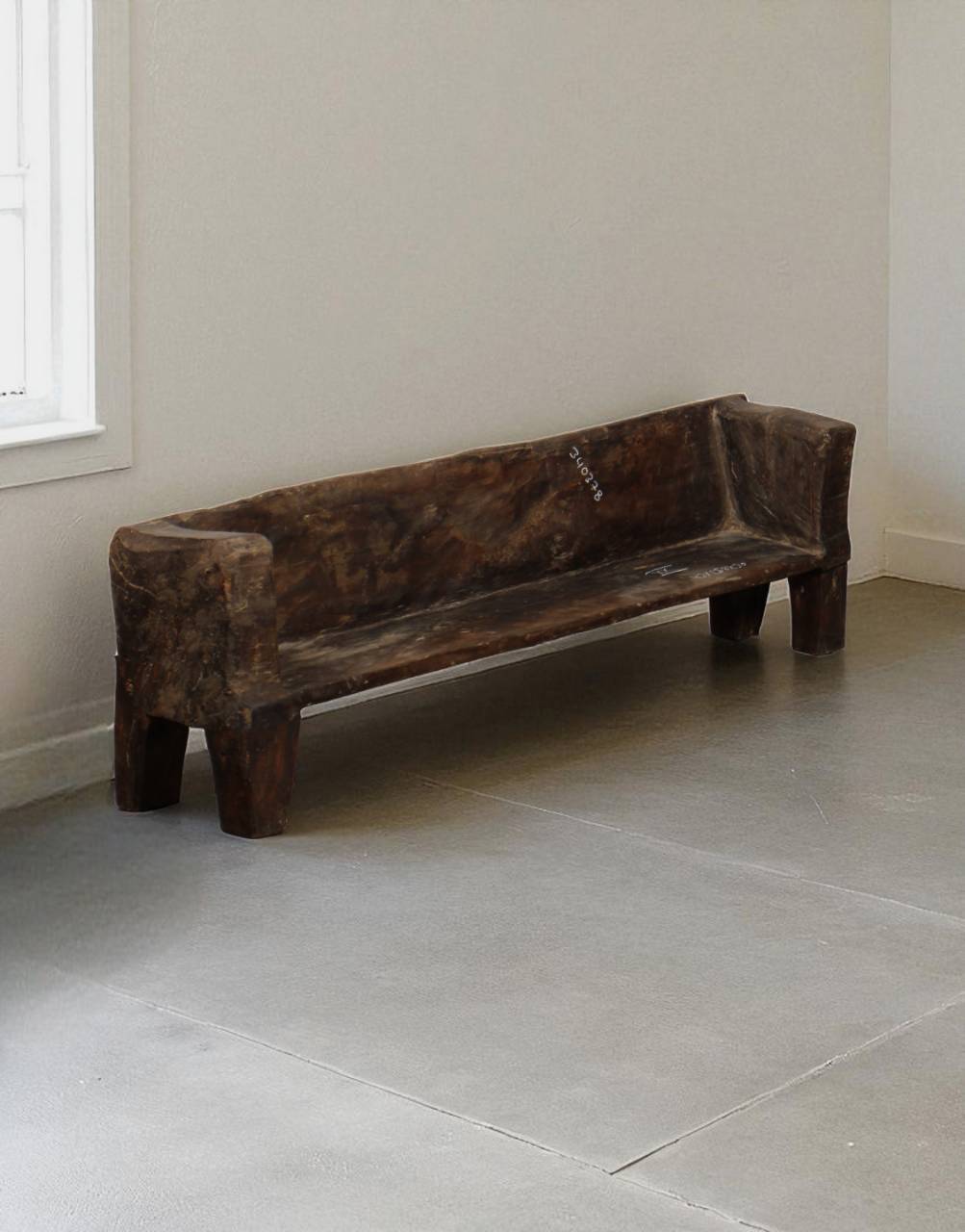 Wooden bench in a minimalistic room with light-colored floor and walls