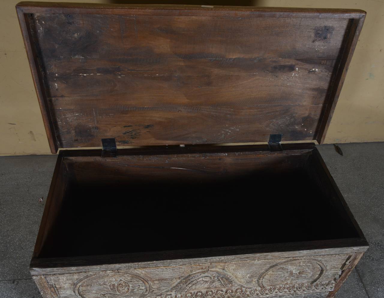 Wooden trunk with decorative patterns on a plain background