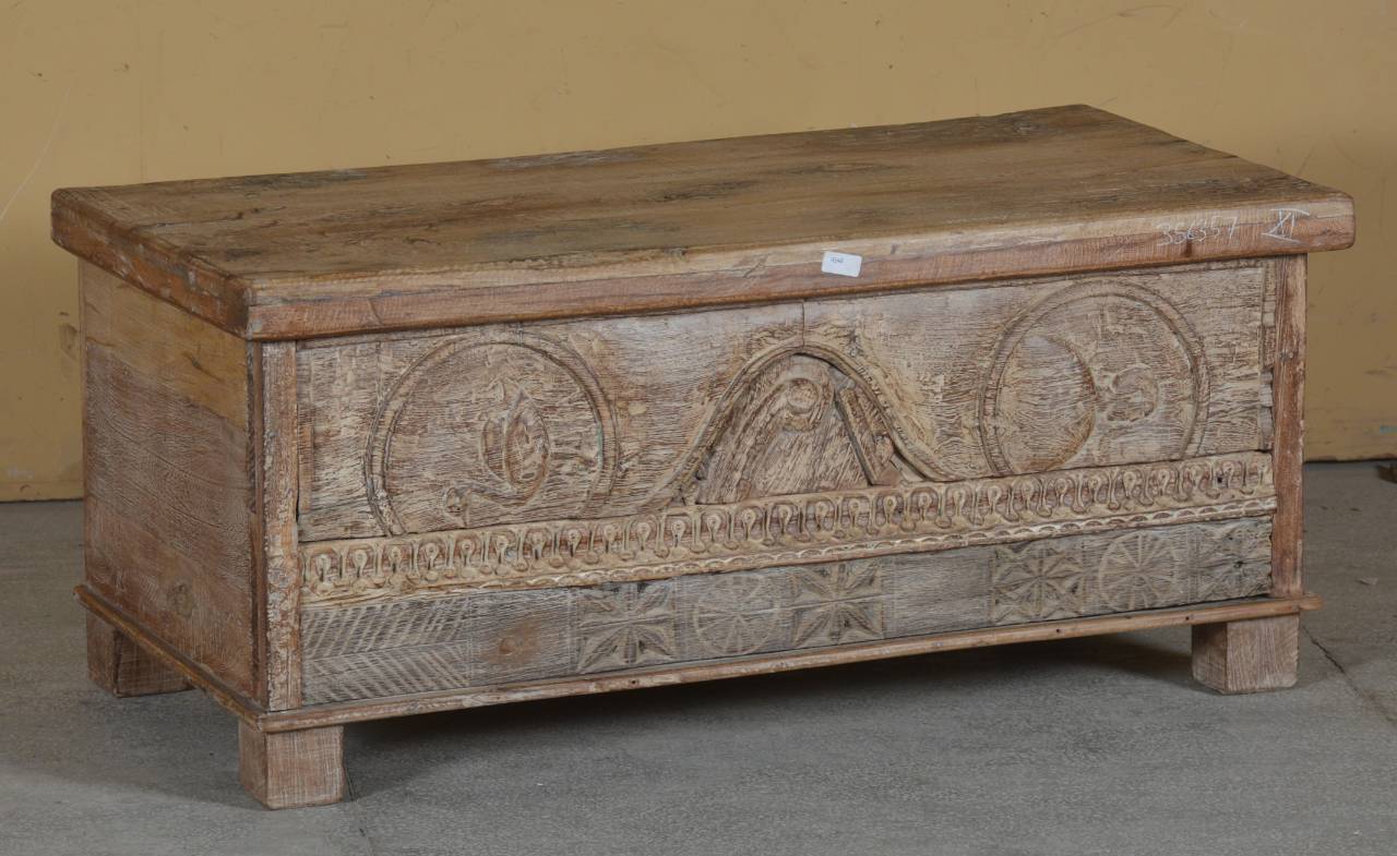 Wooden chest with intricate carvings on a plain background