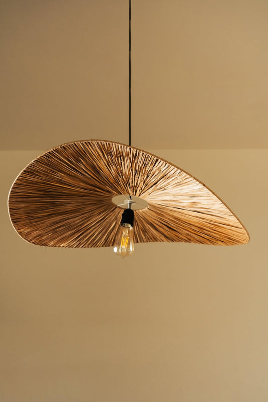 Wooden pendant light with a leaf-like design on a beige background