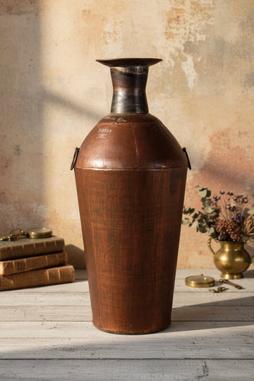 Vintage leather container with metal top on a plain background