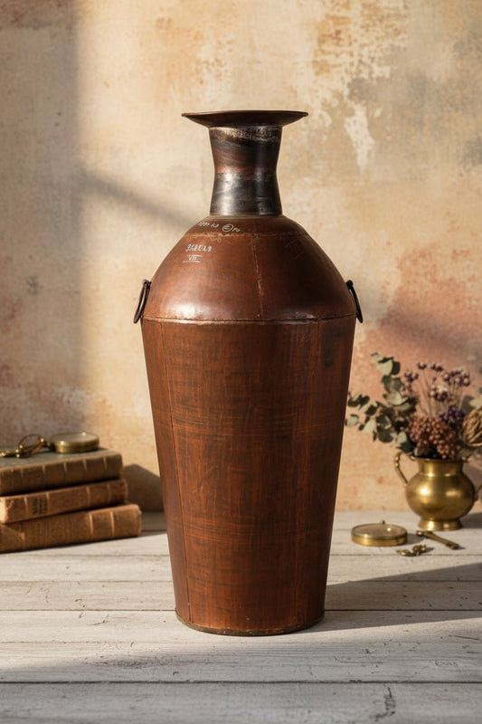 Vintage leather container with metal top on a plain background