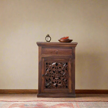 Wooden cabinet with intricate carvings on a beige wall background