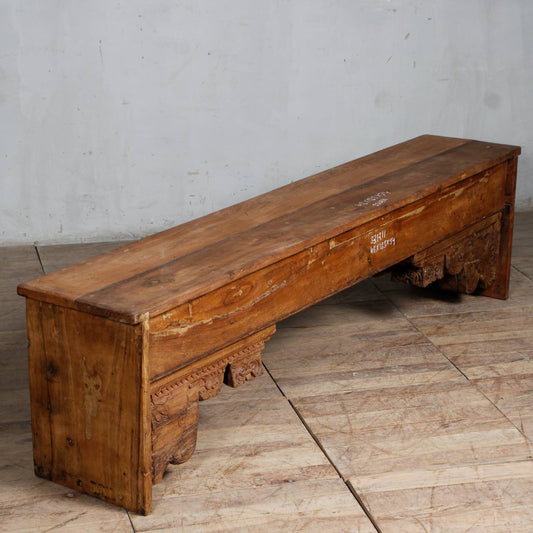 Handcrafted reclaimed wood bench with a rustic natural finish, featuring a sturdy rectangular seat, thick block legs, and visible wood grain that highlights sustainable craftsmanship.