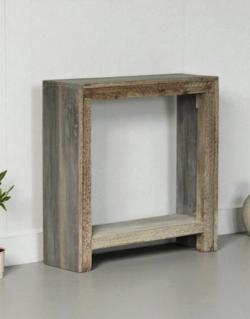 Wooden console table against a white wall