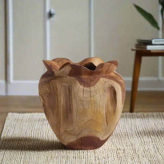 Crafted from a single block of richly grained teak wood, the Rooted Heart Vase celebrates the raw beauty of nature with sculptural form and soulful texture. 