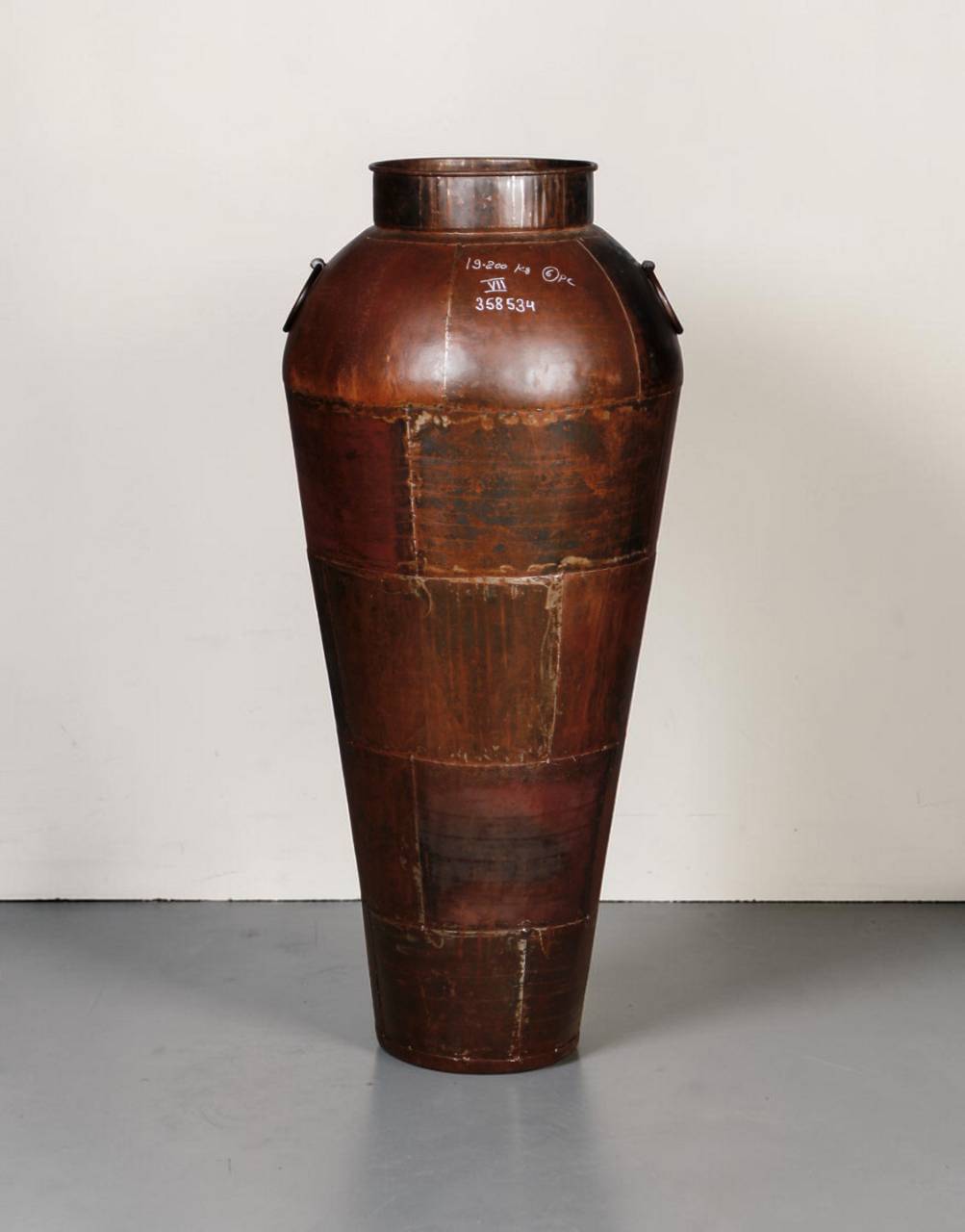 Large brown leather container on a gray surface with a white background