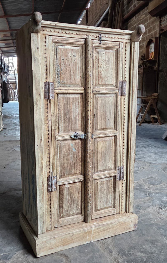 Vintage wooden wardrobe with double doors in a rustic setting