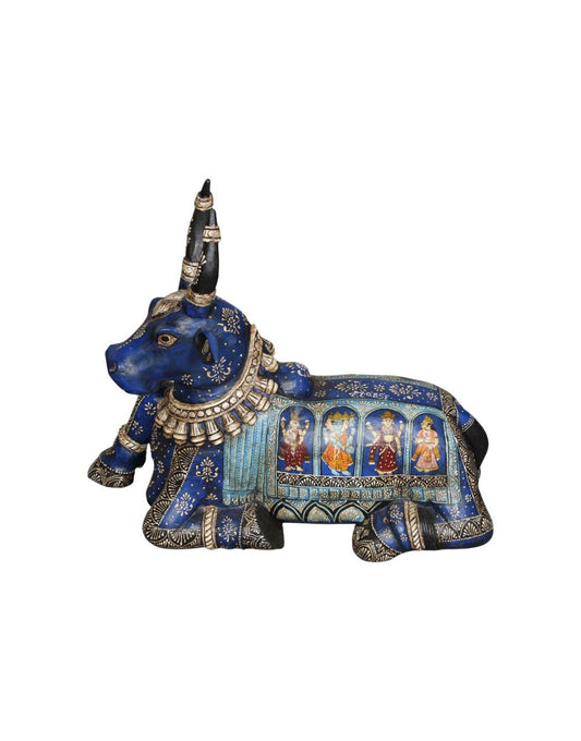 Decorative blue bull figurine with intricate designs on a white background