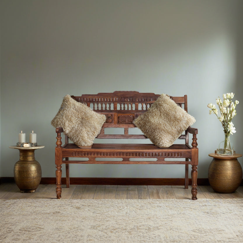 Wooden bench with decorative pillows in a room with a neutral color scheme