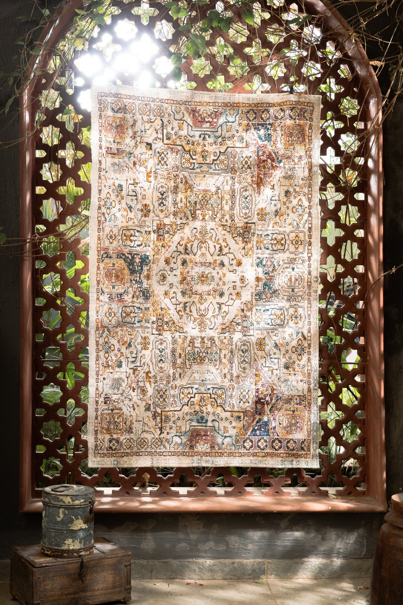 Decorative rug with intricate patterns displayed behind a decorative wooden screen.