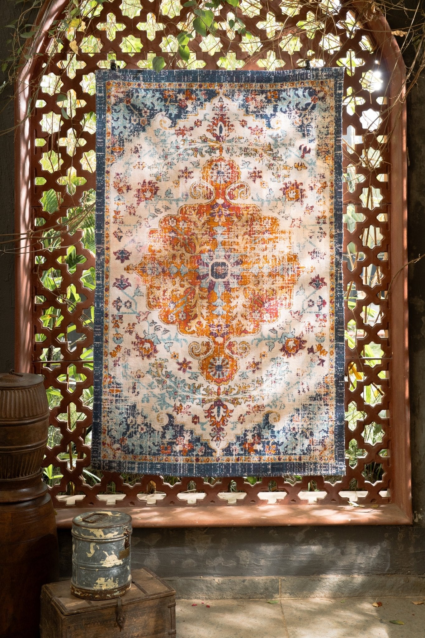 Decorative rug with intricate patterns displayed in a decorative frame.
