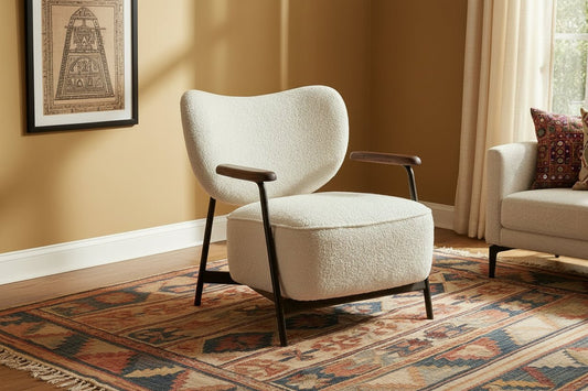 Modern armchair with wooden arms in a room with a window and marble table.