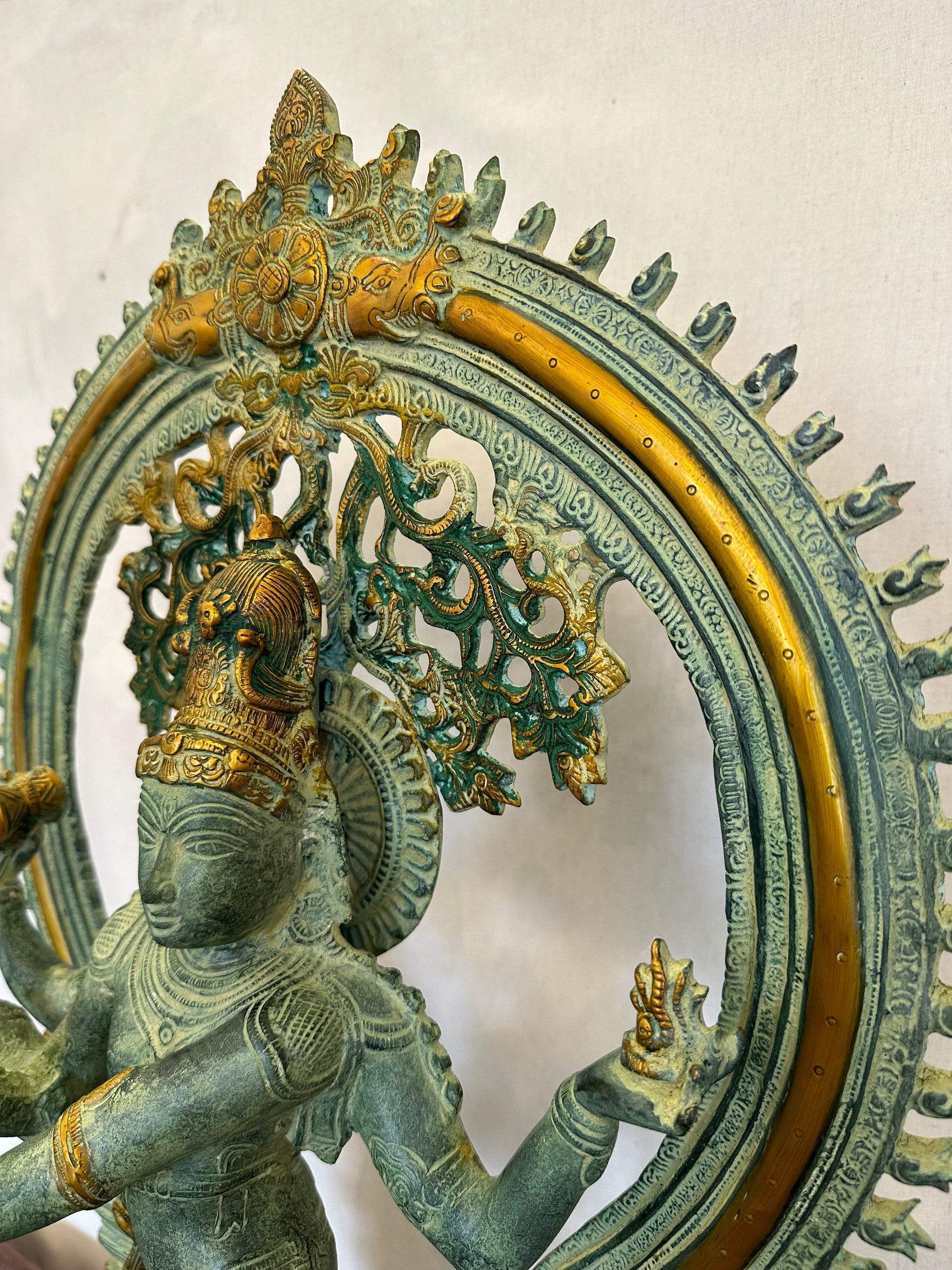 Decorative sculpture of a figure with intricate designs on a white background
